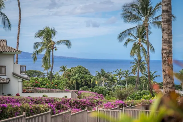 a front view of a house with a garden and a yard
