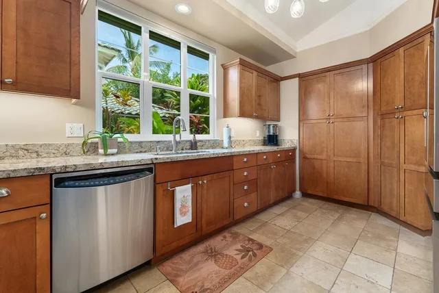 a kitchen with stainless steel appliances granite countertop a refrigerator and a stove