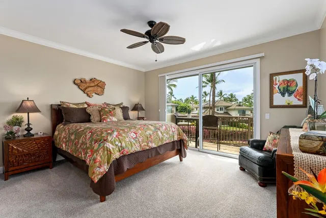 a bedroom with a bed mirror and window