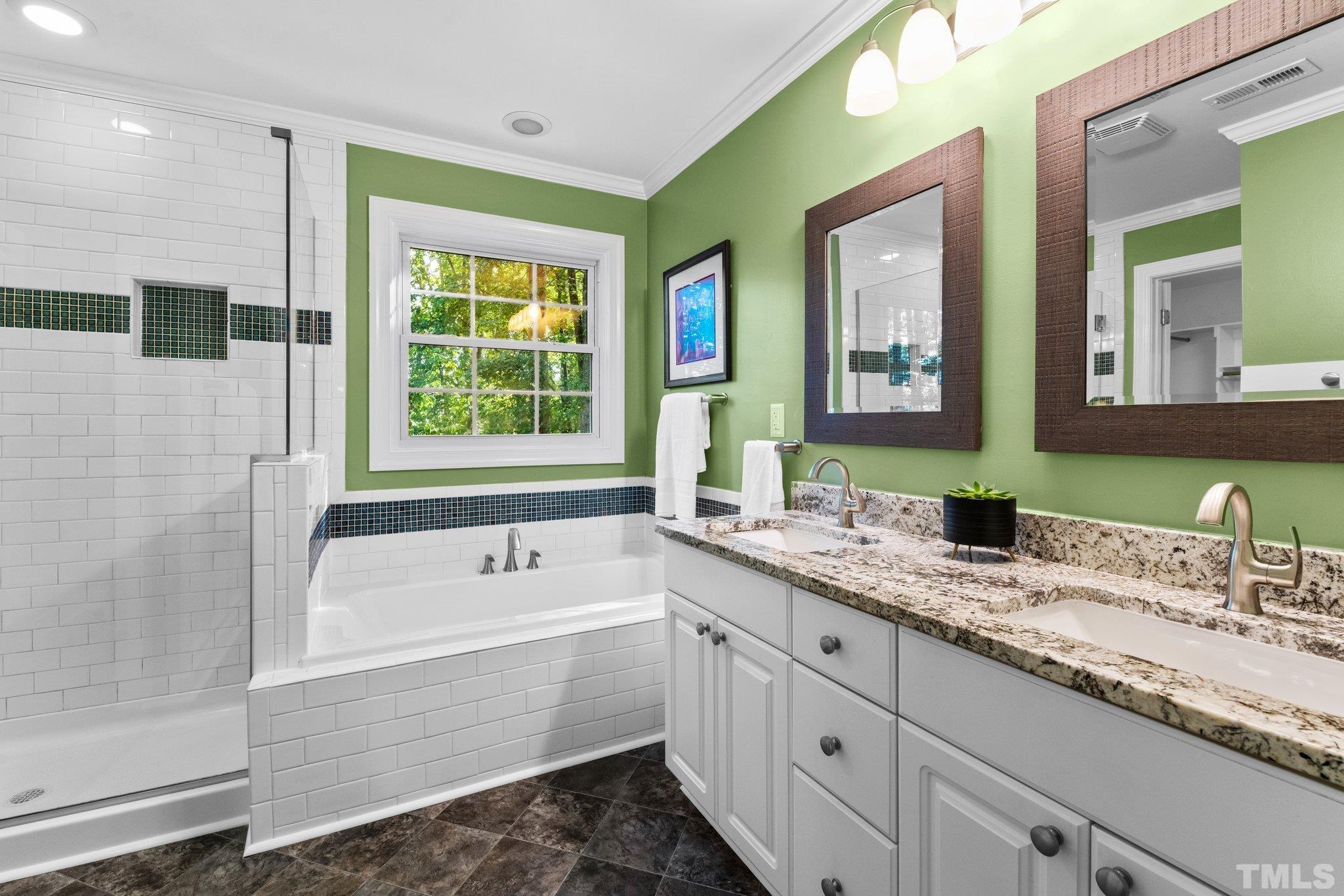 6304 Meerbrook Court Raleigh, NC 27603 - Photo 12 of 30 a bathroom with a tub a sink and a window