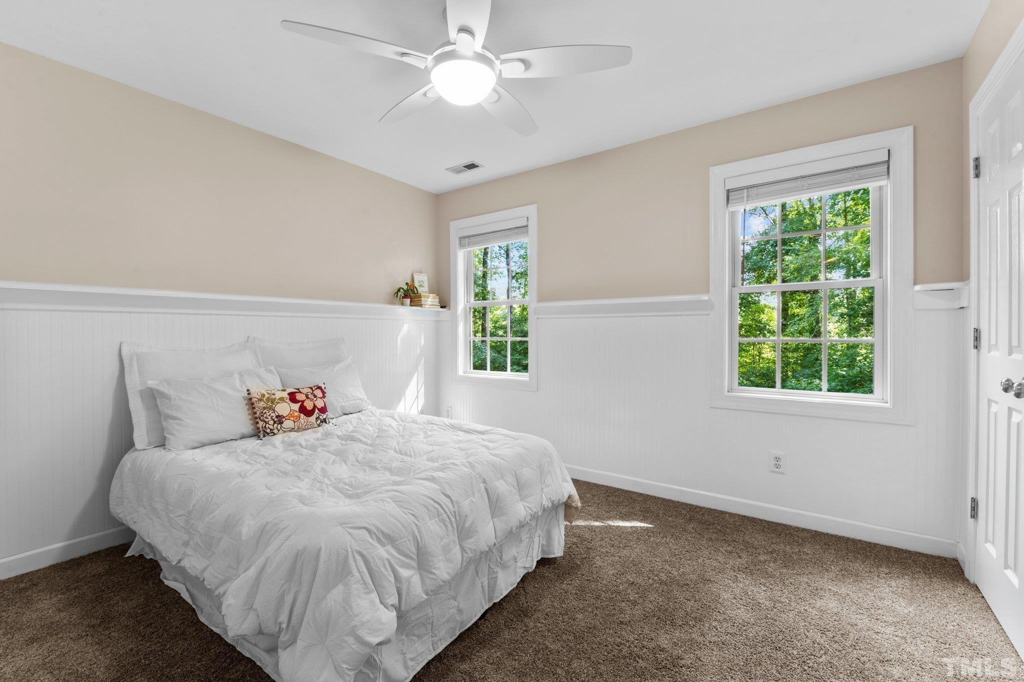 6304 Meerbrook Court Raleigh, NC 27603 - Photo 14 of 30 a bedroom with a bed and a chandelier