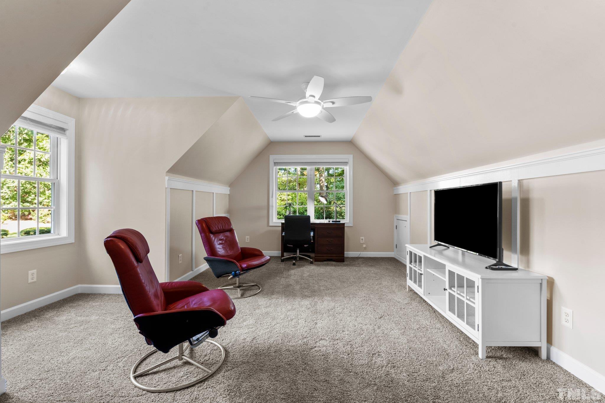 6304 Meerbrook Court Raleigh, NC 27603 - Photo 17 of 30 a living room with furniture and a flat screen tv