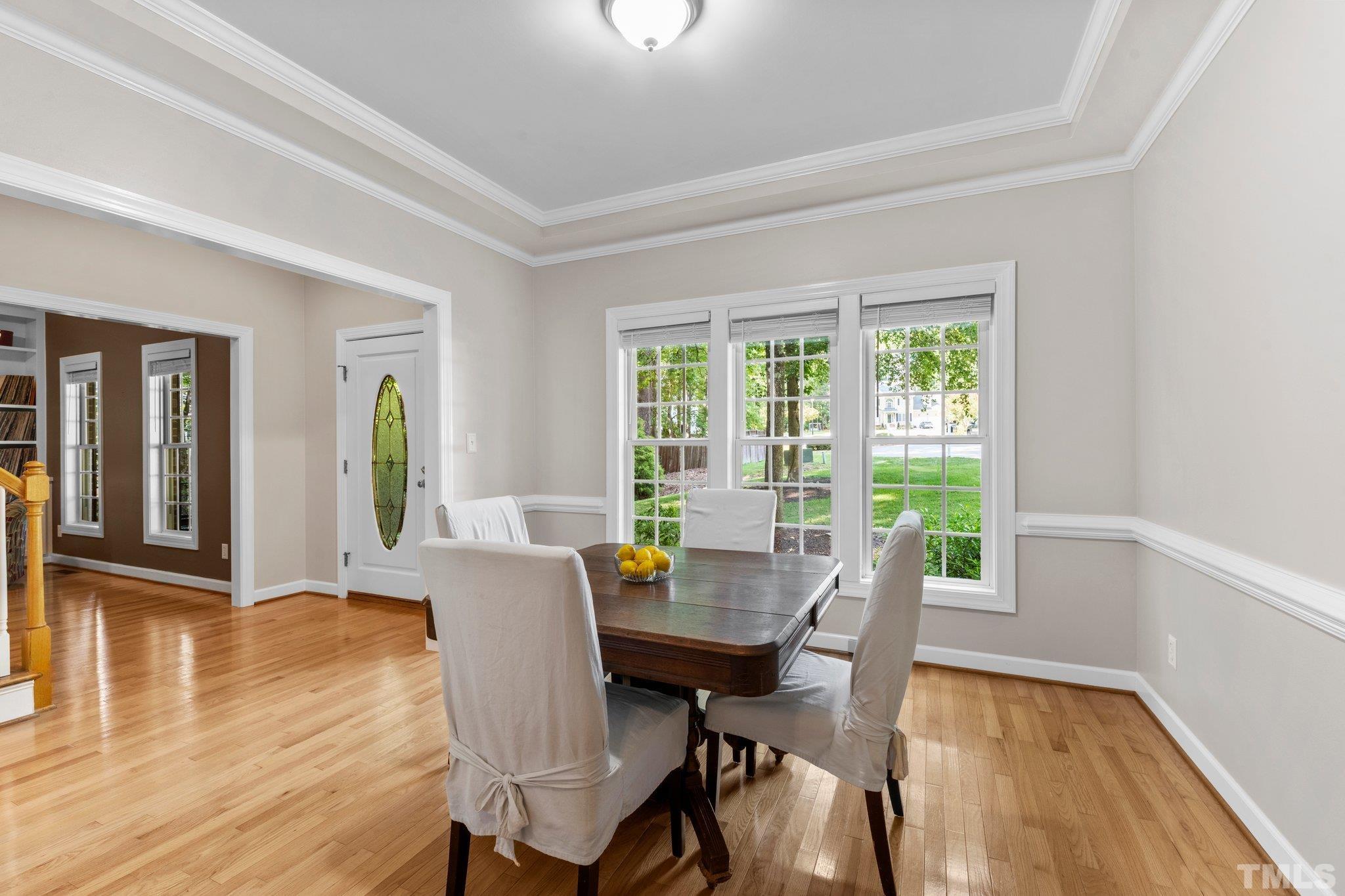 6304 Meerbrook Court Raleigh, NC 27603 - Photo 9 of 30 a view of a dining room with furniture and wooden floor