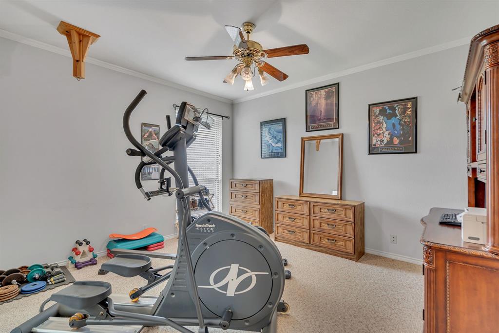 50 Buckingham Lane Allen, TX 75002 - Photo 33 of 39 Workout area with a ceiling fan, ornamental molding, and carpet flooring
