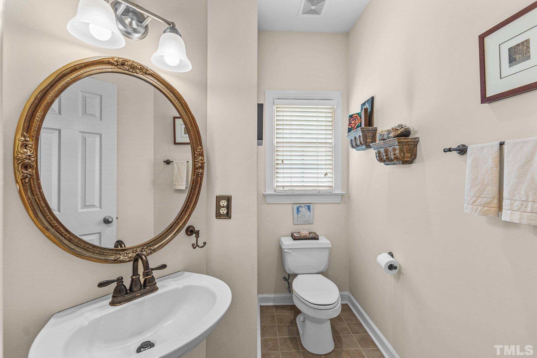 4009 Sunridge Road Raleigh, NC 27613 - Photo 19 of 35 a bathroom with a toilet a sink and a mirror