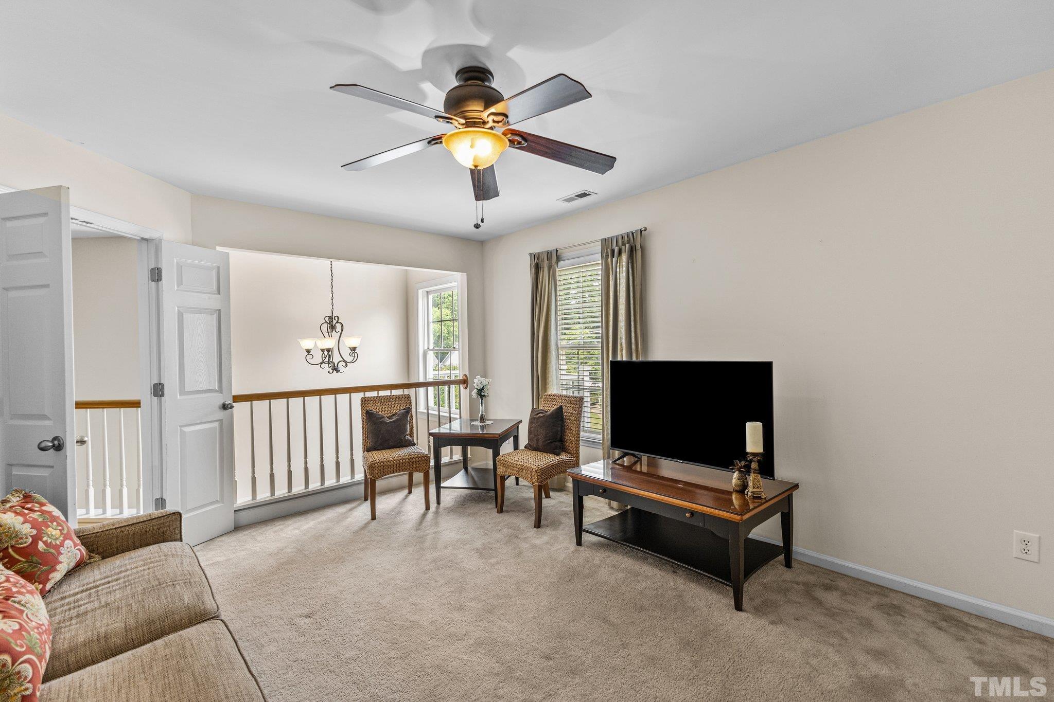 4009 Sunridge Road Raleigh, NC 27613 - Photo 21 of 35 a living room with furniture and a flat screen tv