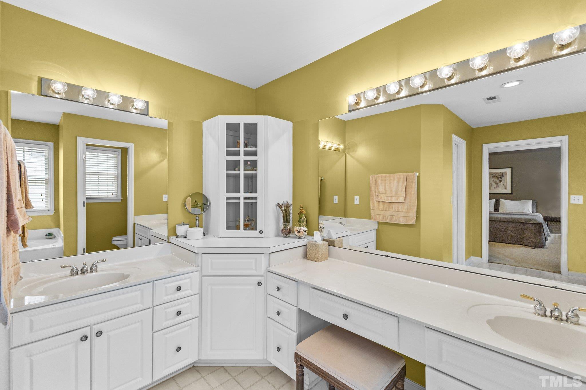 4009 Sunridge Road Raleigh, NC 27613 - Photo 26 of 35 a spacious bathroom with a sink double vanity and a mirror