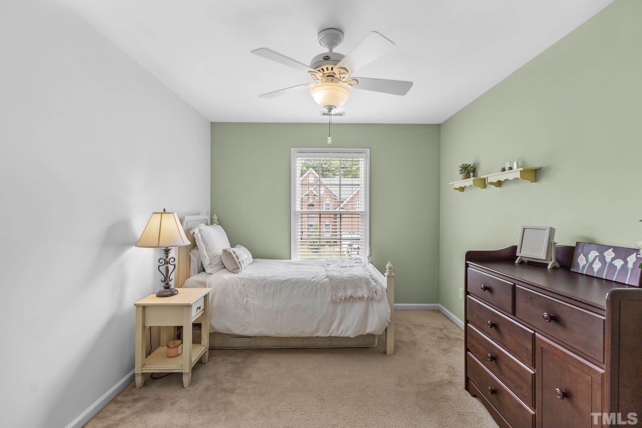 4009 Sunridge Road Raleigh, NC 27613 - Photo 31 of 35 a bedroom with a bed and a chandelier