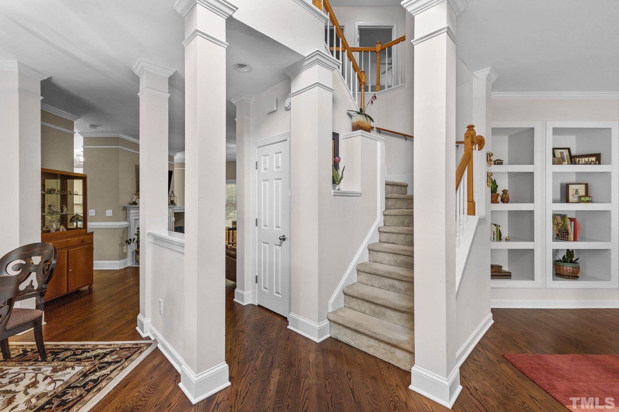 4009 Sunridge Road Raleigh, NC 27613 - Photo 5 of 35 a view of a hallway with wooden floor and staircase
