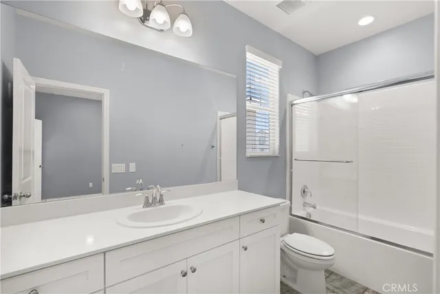 a bathroom with a shower a toilet and a sink