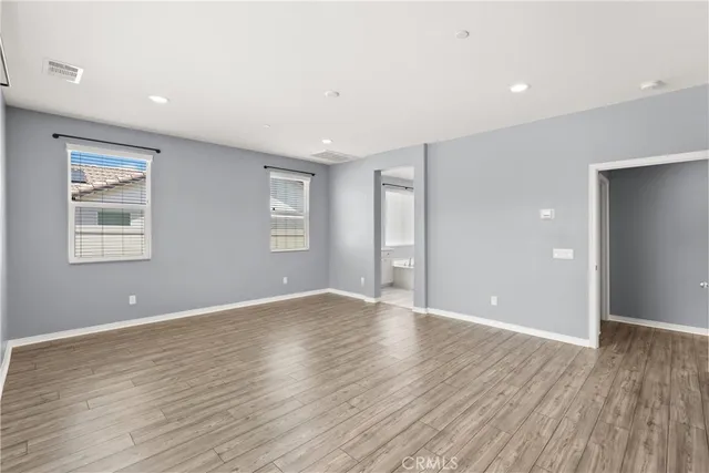 a spacious bathroom with a tub sink shower and mirror