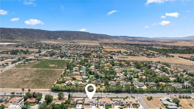 an aerial view of residential houses with outdoor space and street view