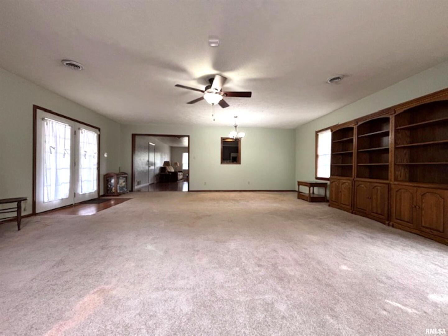 2633 South Broadway Salem, IL 62881 - Photo 15 of 39 a view of an empty room with a window and a kitchen