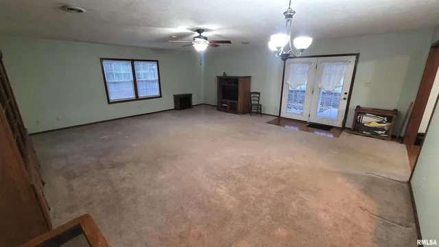 a view of a livingroom with furniture and a window
