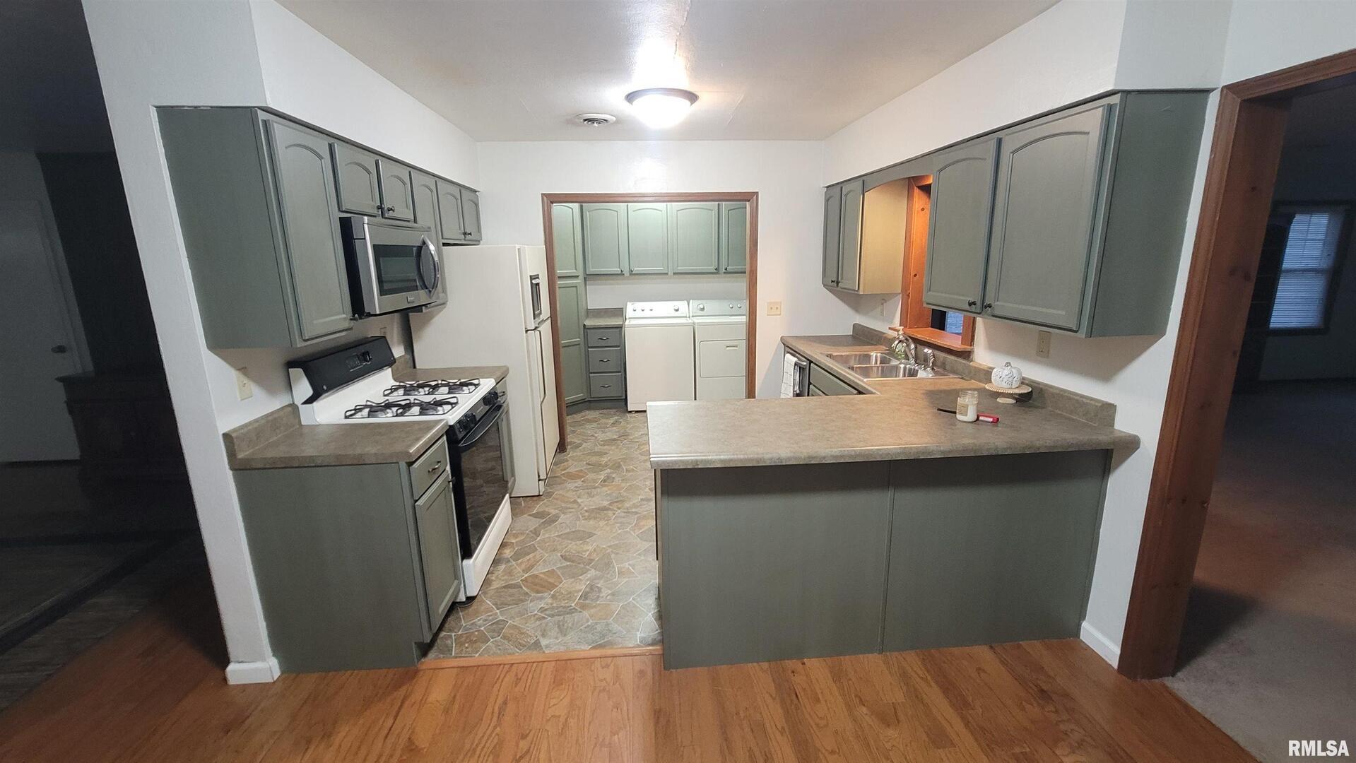 2633 South Broadway Salem, IL 62881 - Photo 31 of 39 a kitchen with sink a refrigerator and chairs