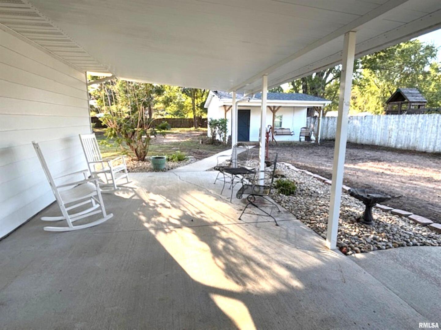 2633 South Broadway Salem, IL 62881 - Photo 4 of 39 a view of a patio with chairs and floor to ceiling window