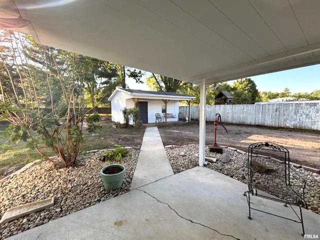 a view of a patio with table and chairs potted plants with wooden floor and seating space
