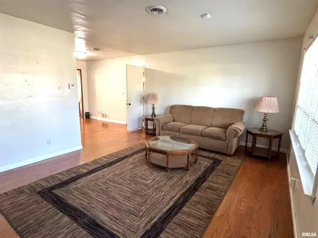 a living room with furniture and a rug