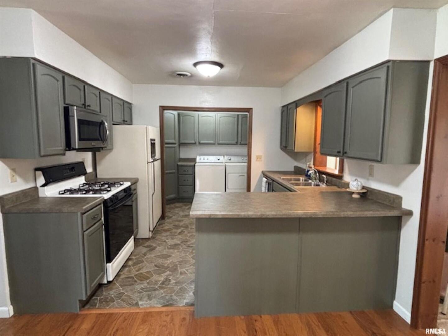 2633 South Broadway Salem, IL 62881 - Photo 10 of 39 a kitchen with stainless steel appliances granite countertop a sink stove and refrigerator