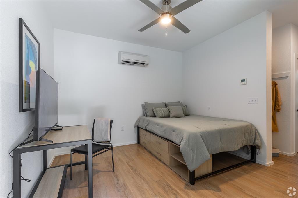 596 West 9th Street, Unit 405 Dallas, TX 75208 - Photo 23 of 25 a bedroom with a bed a desk and chair