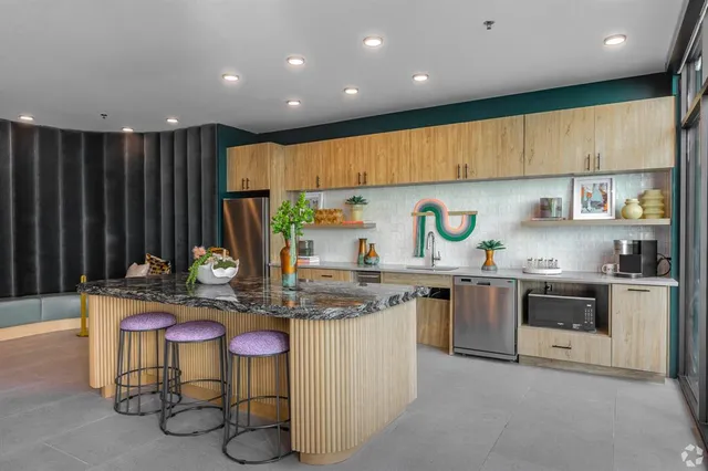 a kitchen with granite countertop cabinets and chairs