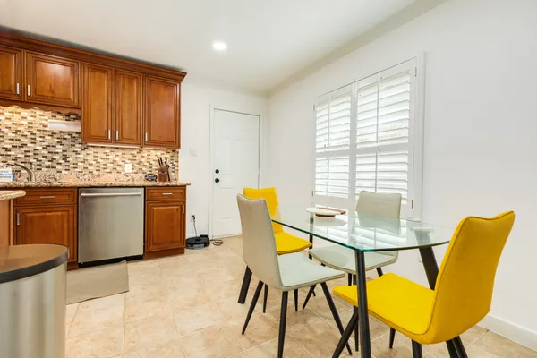a view of a dining room with furniture and a window
