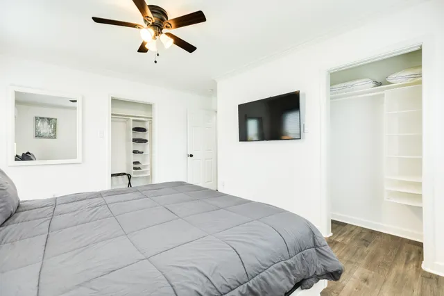 a bedroom with a bed and a flat screen tv