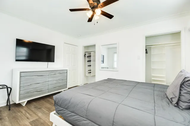 a bedroom with a bed and a flat screen tv