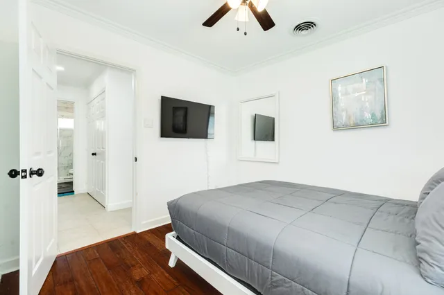 a bedroom with a bed and a flat screen tv