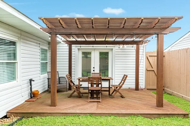 a view of a patio with table and chairs