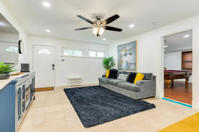 a living room with furniture and a chandelier