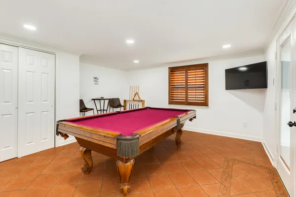 a room with pool table and flat screen tv