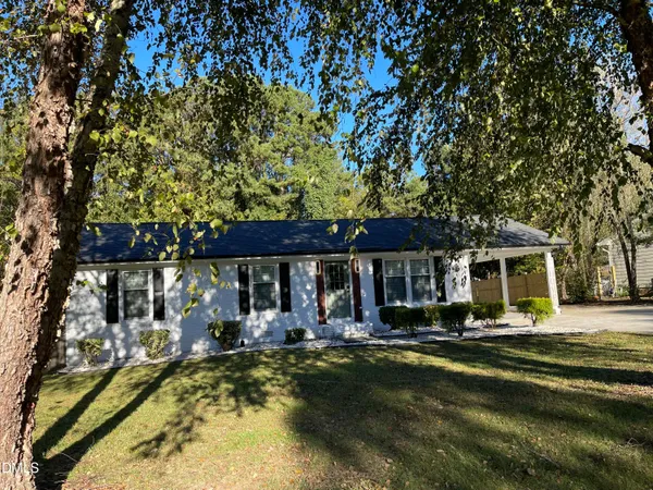 a view of a house with swimming pool and sitting area