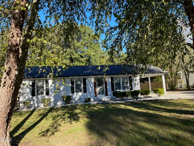 a view of a house with swimming pool and sitting area