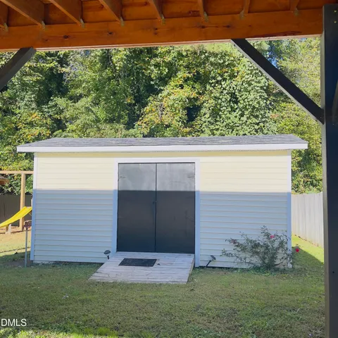 a view of house with outdoor space and sitting area