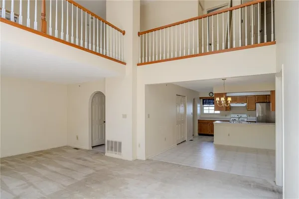 a view of a hallway with kitchen and entryway
