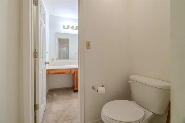 a white toilet sitting next to a bathroom sink