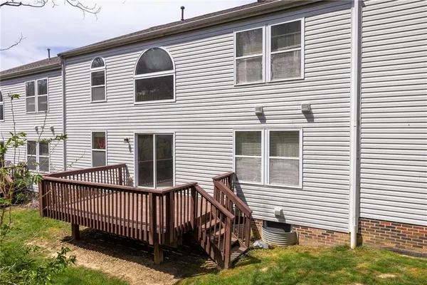 a view of a house with wooden deck