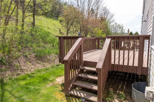 a view of balcony with wooden floor and fence
