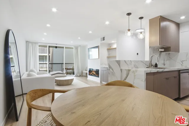 a spacious bathroom with a granite countertop sink and a large mirror