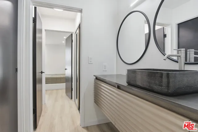 a living room with a mirror and a glass door