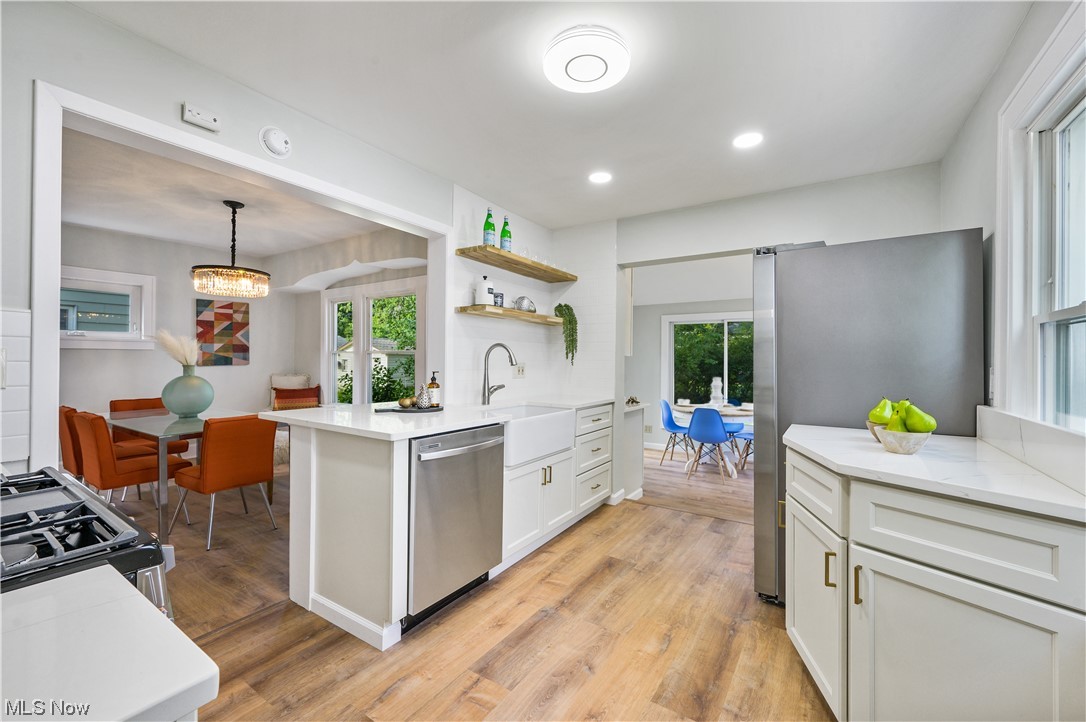 1606 Maple Road Cleveland Heights, OH 44121 - Photo 11 of 30 Fabulous eat-in kitchen with white soft close cabinets, quartz countertop and brand new stainless steel appliances(2023) is perfect for your all cooking needs. Just off the Kitchen, there is breakfast area with beautiful SKY LIGHT