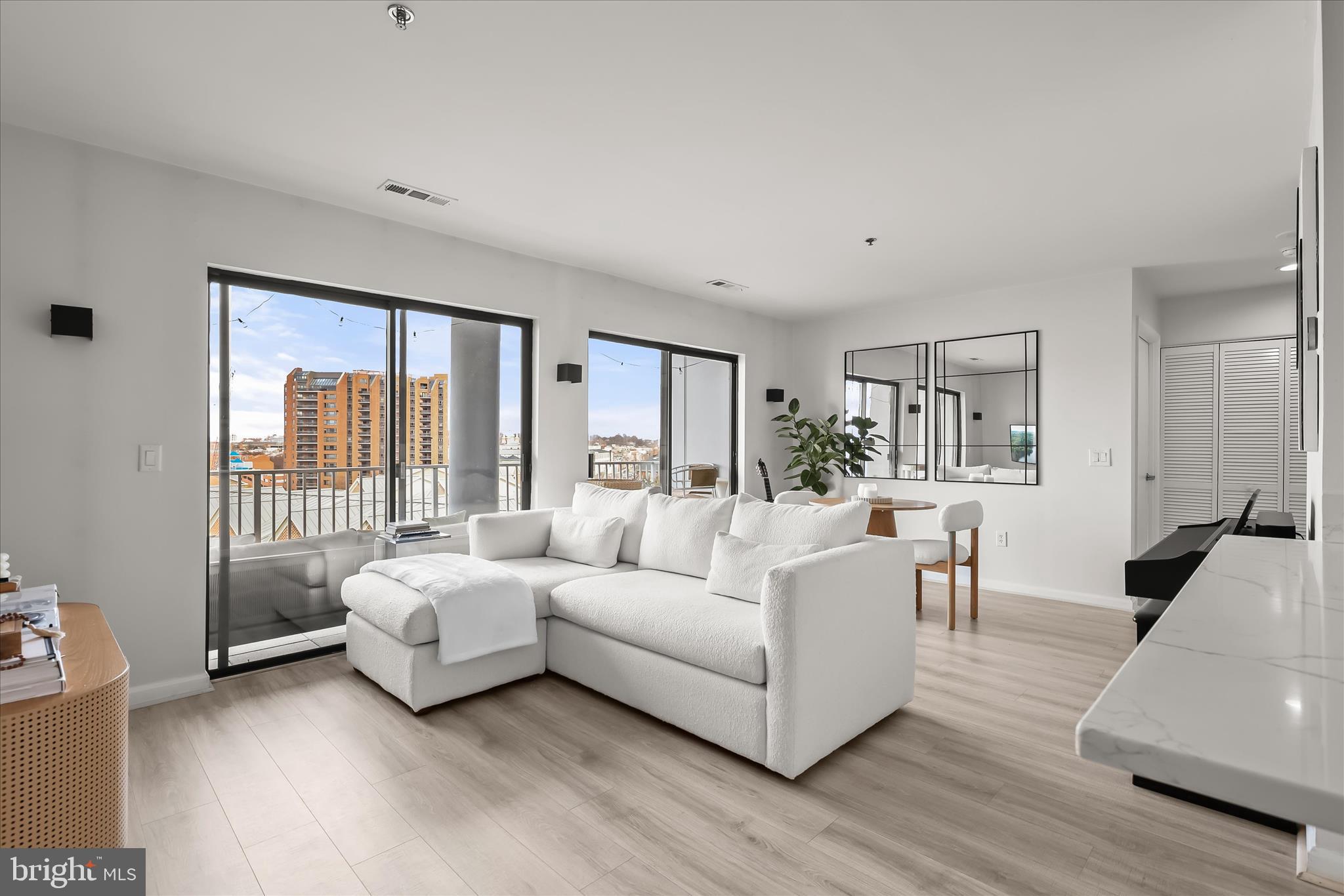 2702 Lighthouse Point East, Unit 522 Baltimore, MD 21224 - Photo 11 of 50 a living room with furniture and a large window