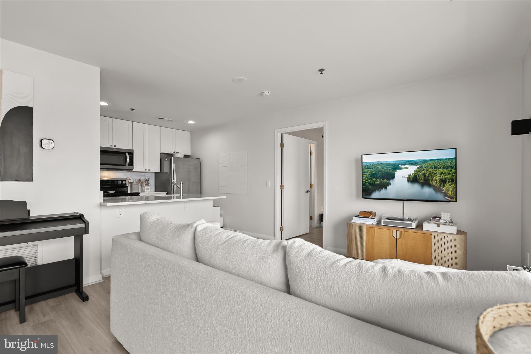 2702 Lighthouse Point East, Unit 522 Baltimore, MD 21224 - Photo 12 of 50 a living room with furniture and a couch