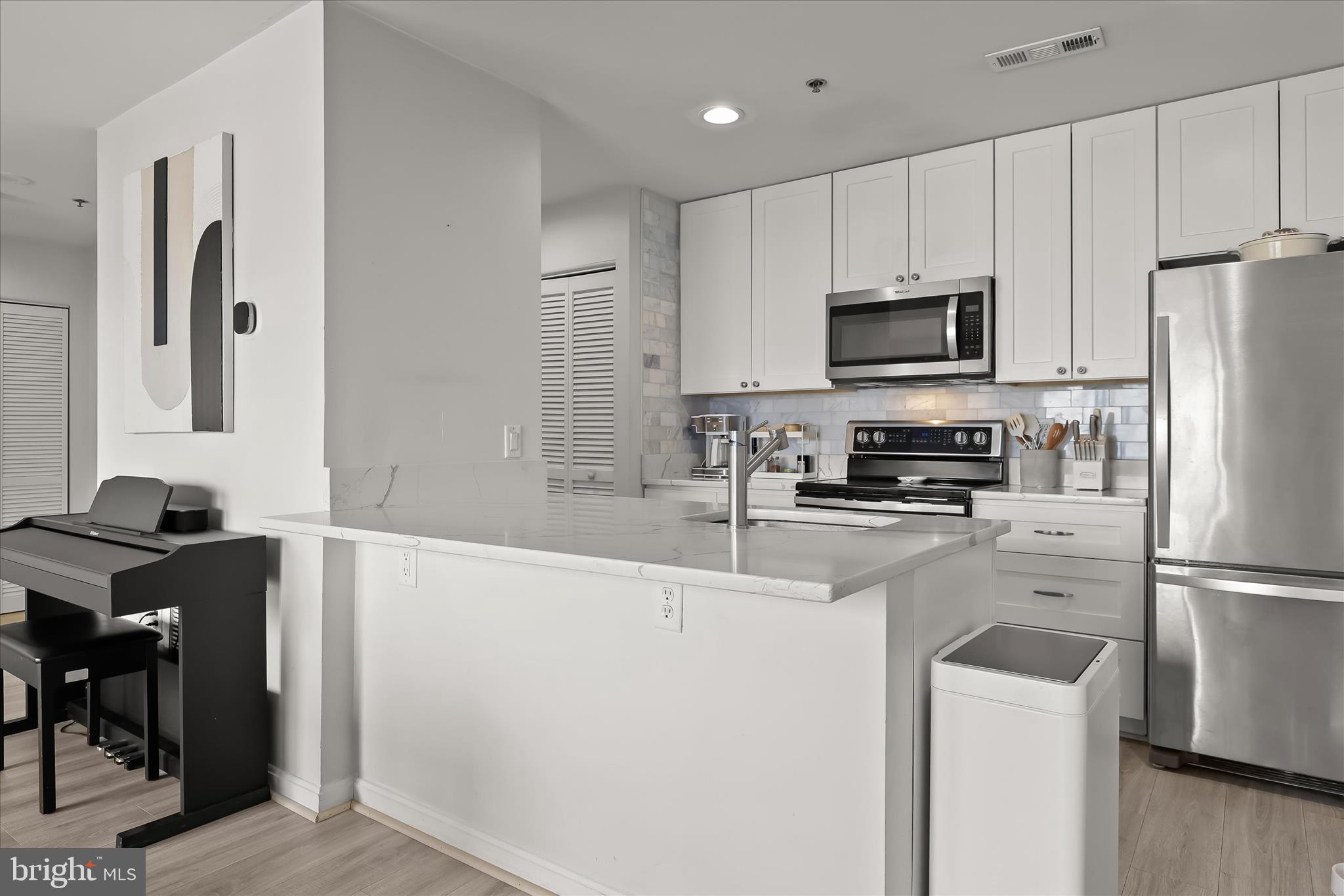 2702 Lighthouse Point East, Unit 522 Baltimore, MD 21224 - Photo 14 of 50 a kitchen with stainless steel appliances a refrigerator stove microwave and sink