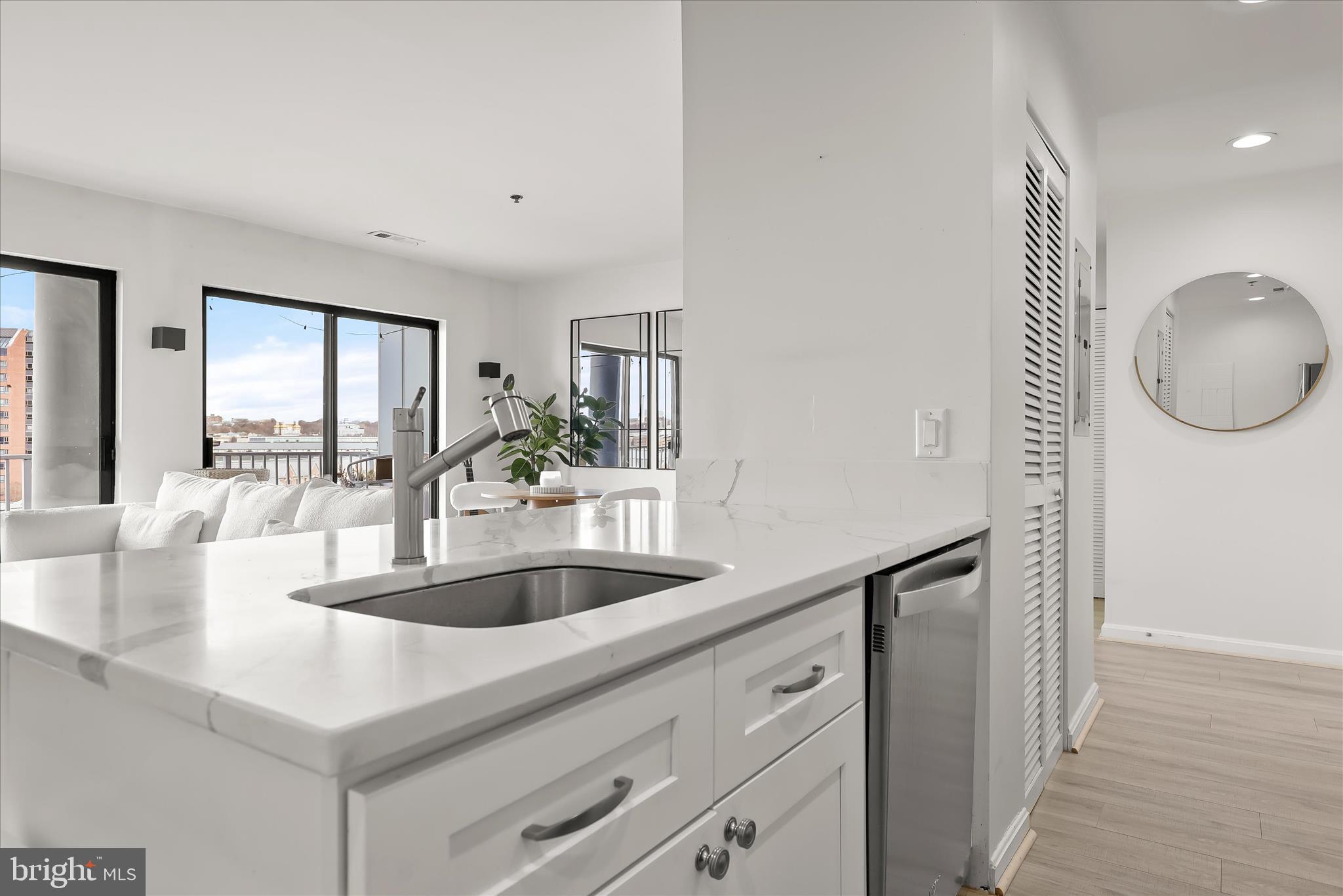 2702 Lighthouse Point East, Unit 522 Baltimore, MD 21224 - Photo 18 of 50 a kitchen with granite countertop a sink and a wooden floor