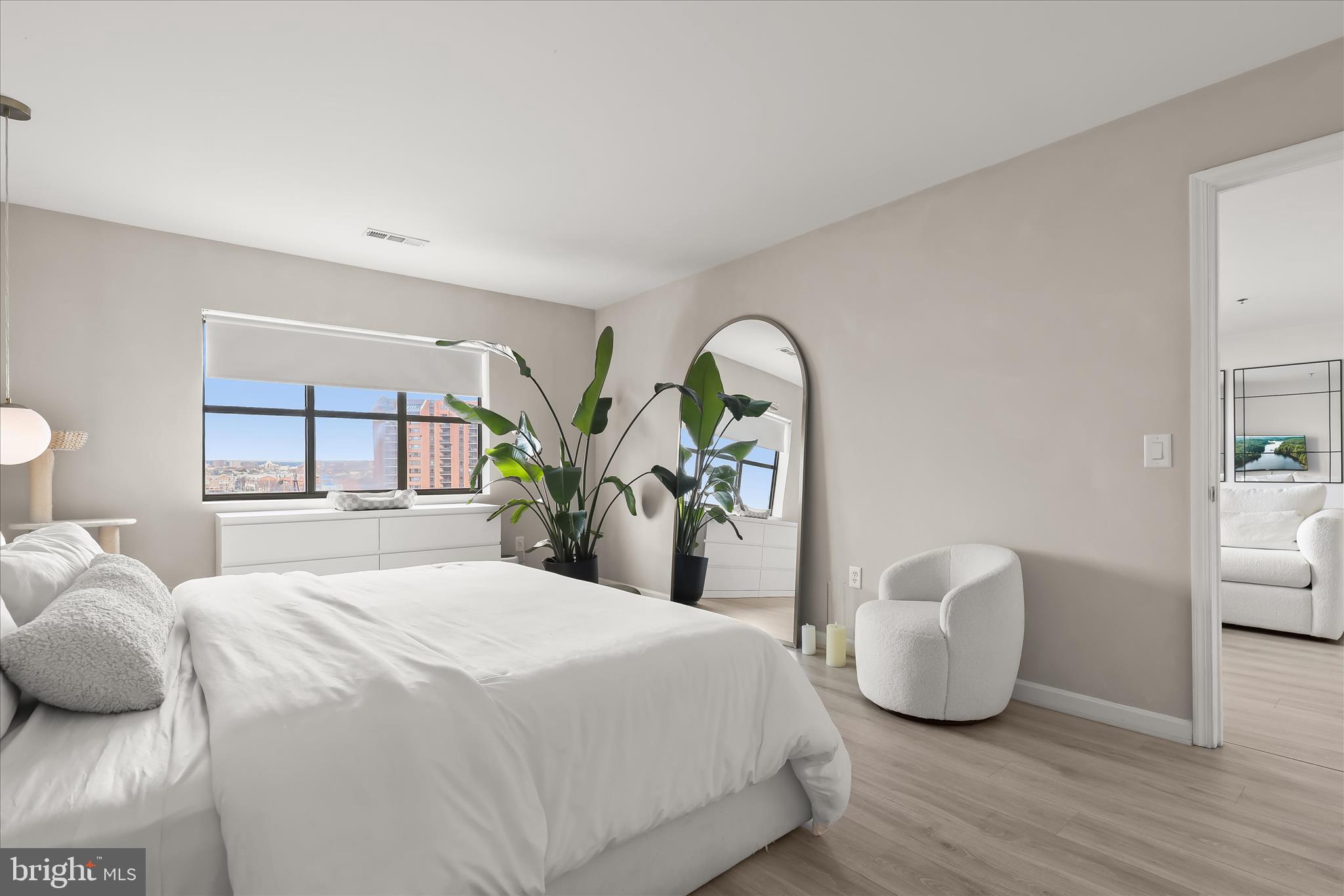 2702 Lighthouse Point East, Unit 522 Baltimore, MD 21224 - Photo 20 of 50 a bedroom with a bed and a window