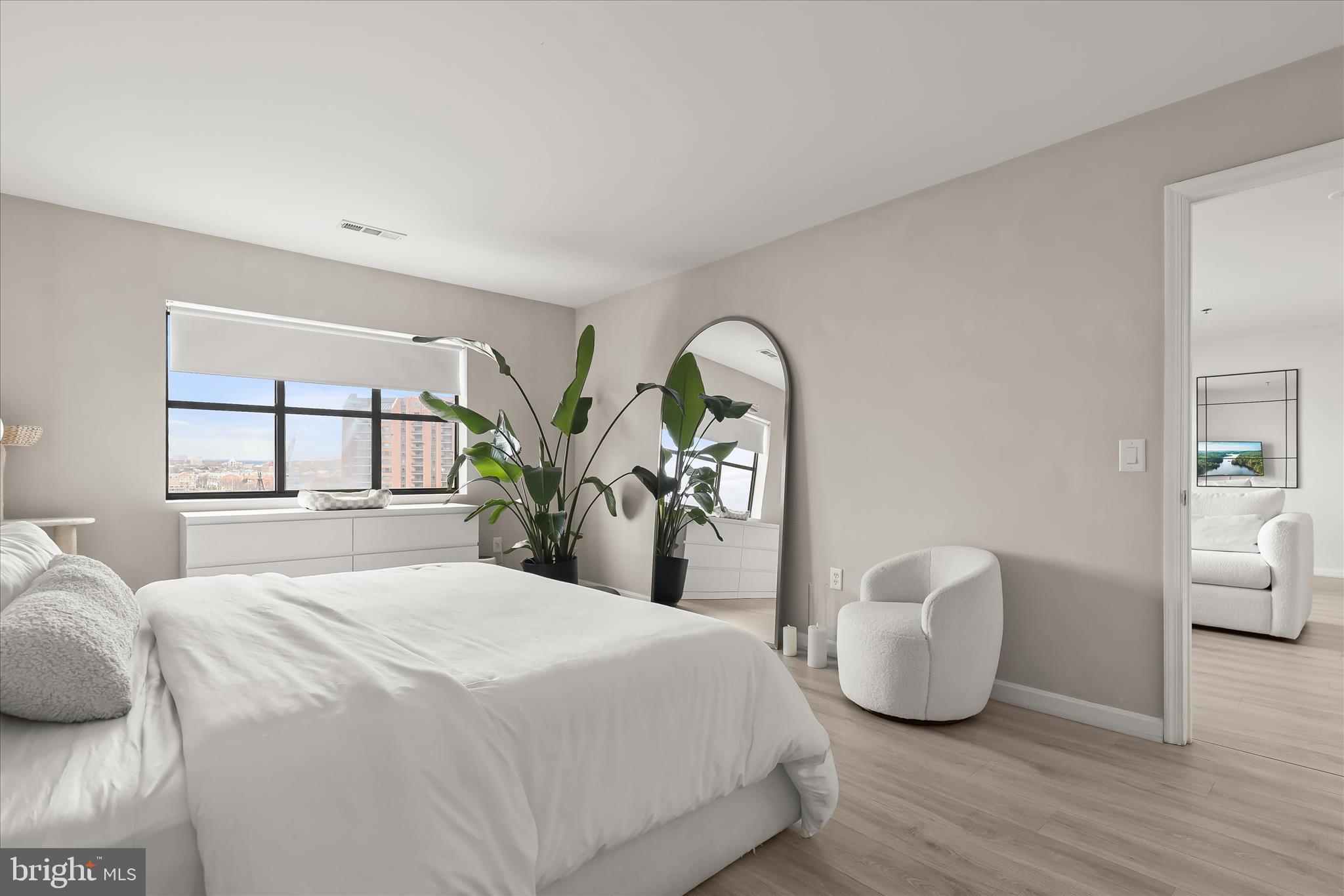 2702 Lighthouse Point East, Unit 522 Baltimore, MD 21224 - Photo 23 of 50 a bedroom with bed and window