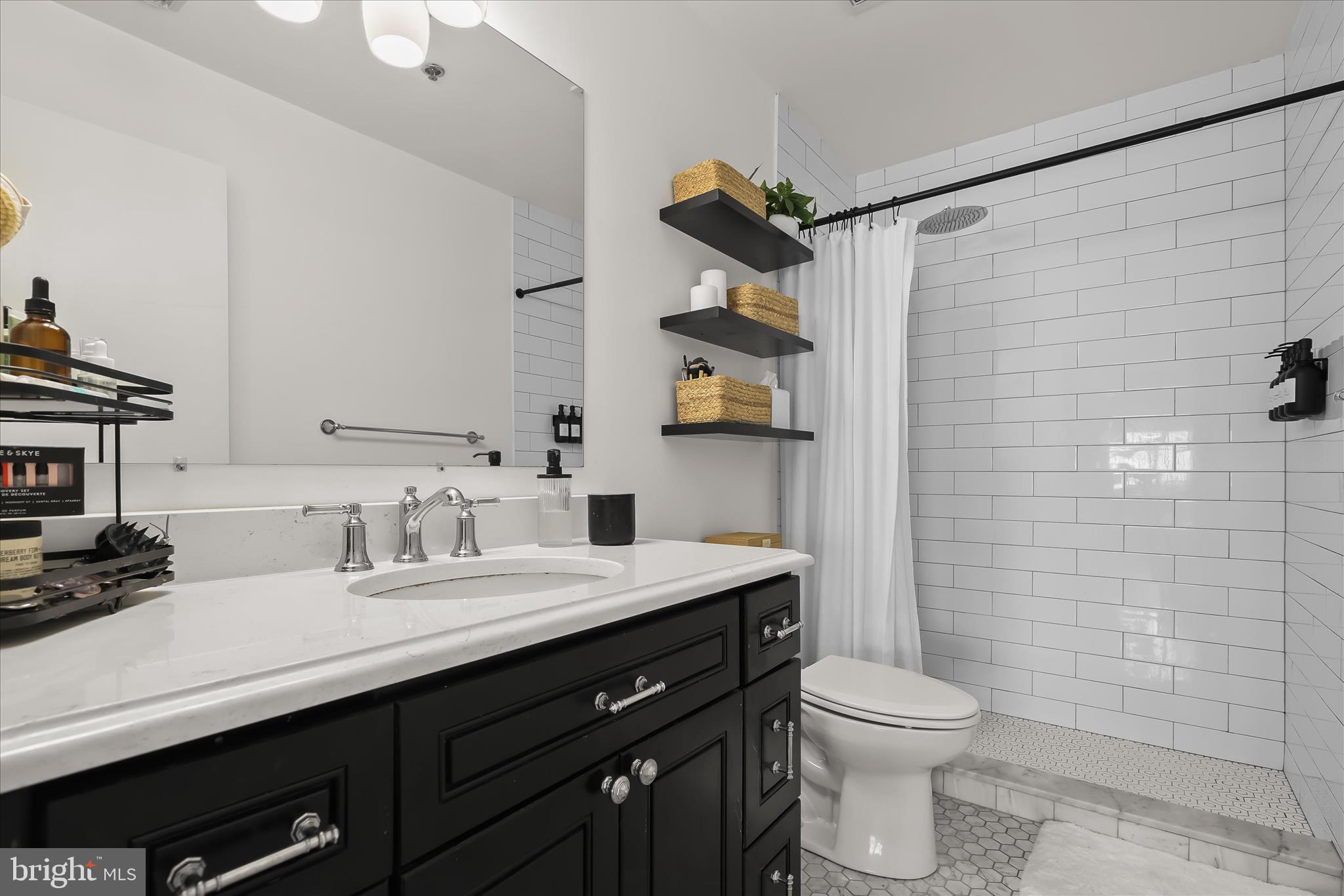 2702 Lighthouse Point East, Unit 522 Baltimore, MD 21224 - Photo 24 of 50 a bathroom with a sink a toilet and shower