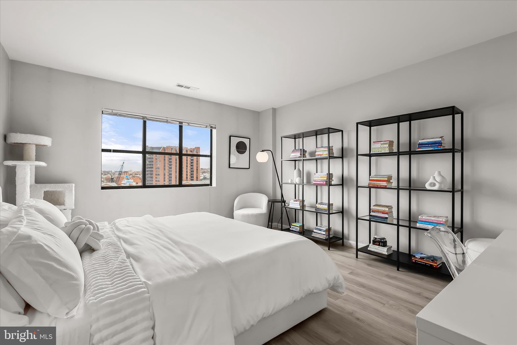 2702 Lighthouse Point East, Unit 522 Baltimore, MD 21224 - Photo 25 of 50 a bedroom with a large bed and a window